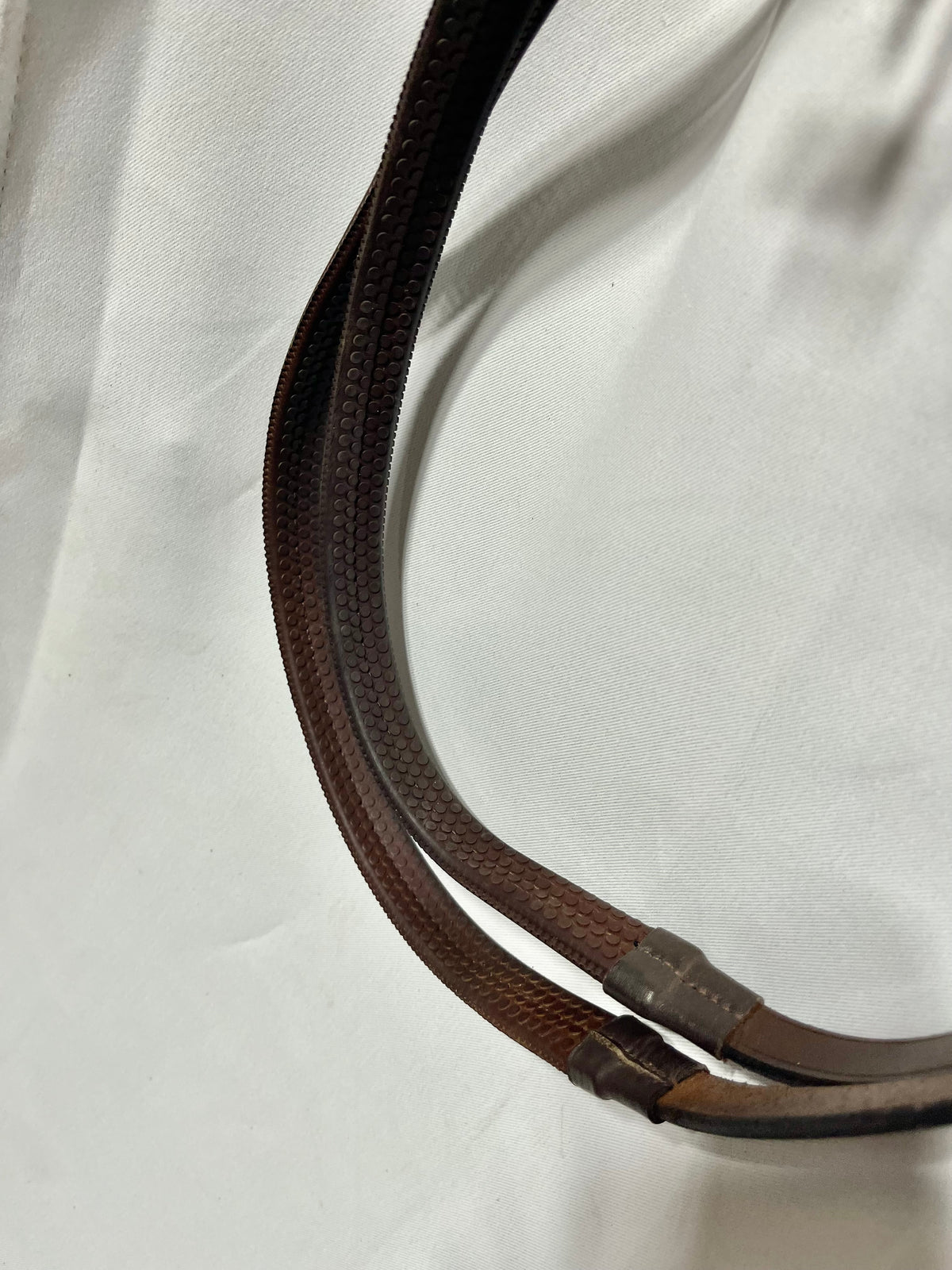56" Kris brand Brown rubber English reins with stoppers on end and bridle hook end fasteners, like new