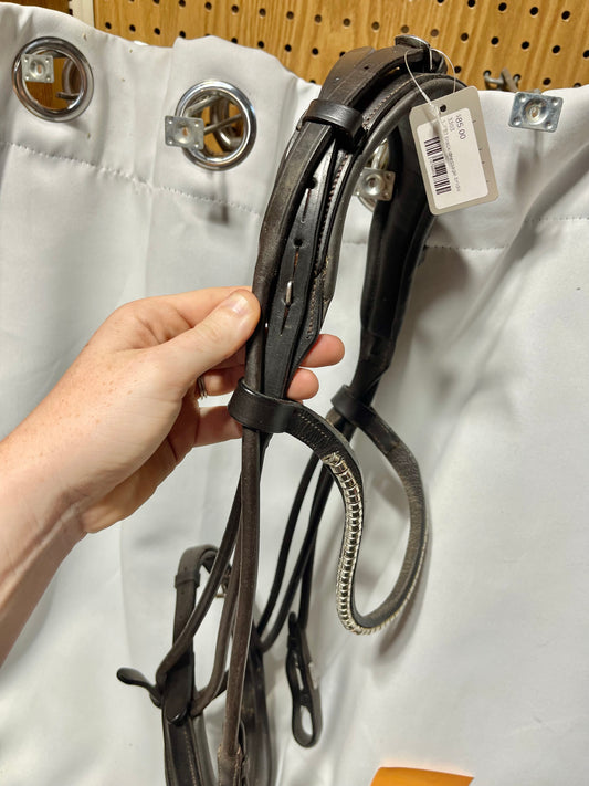 Full Havana brown Lumier bridle w/flash and clincher brow, with cheeks that fasten up and over the crown. One broken leather keeper on throatlatch (pictured)