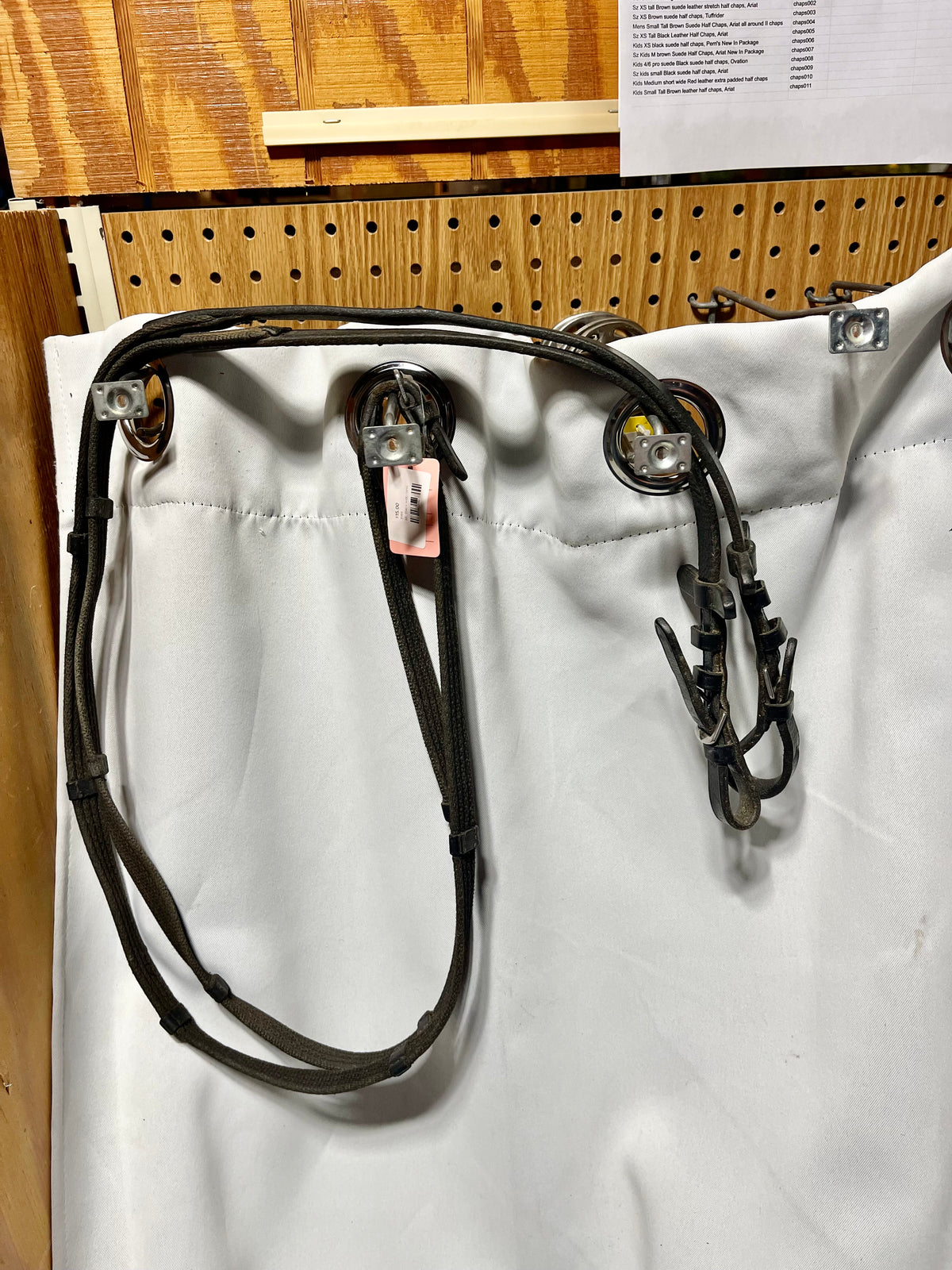 56" x 5/8" English Black Cotton webbed reins with leather stoppers and leather ends. Buckle ends