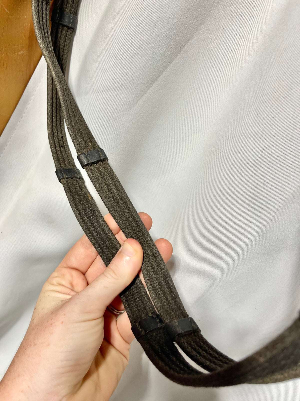 56" x 5/8" English Black Cotton webbed reins with leather stoppers and leather ends. Buckle ends