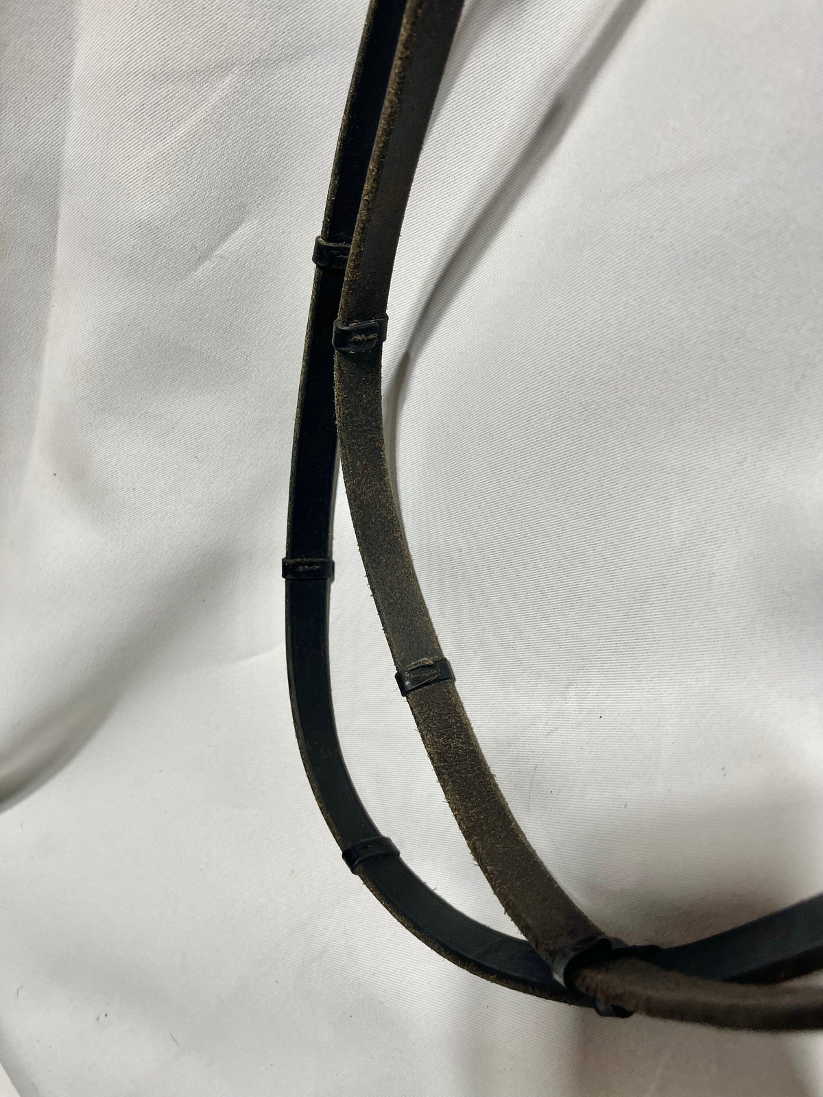 56" Black all leather smooth English reins w/leather stoppers, bridle hook ends. Well used but still good condition