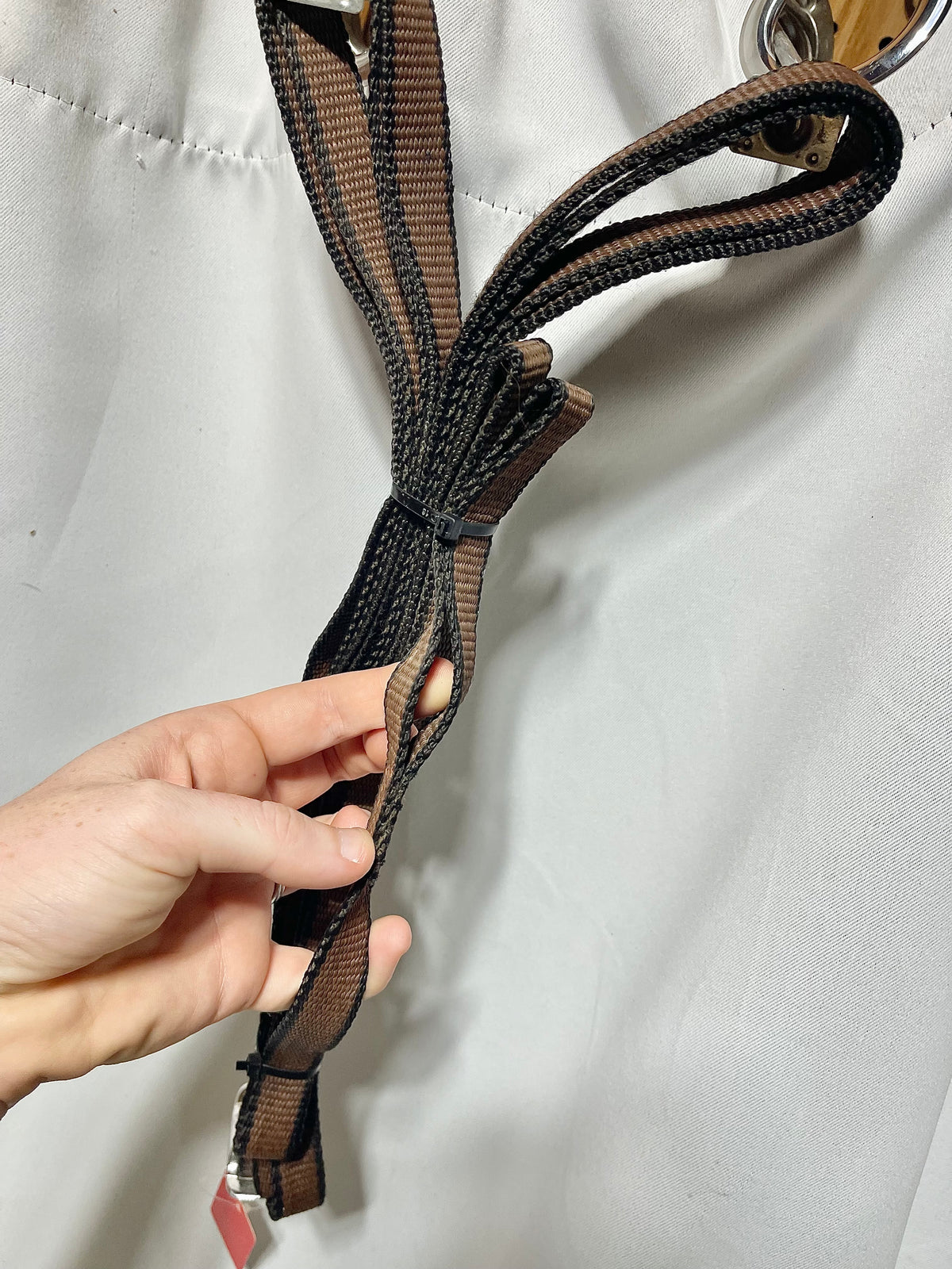 Brown and black nylon 3/4" lightweight side reins or draw reins with loops on one end. No snaps