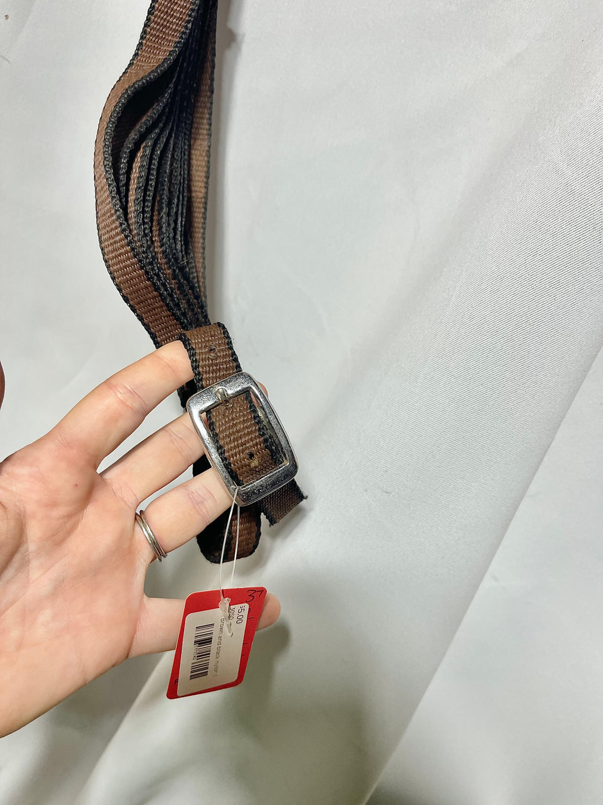 Brown and black nylon 3/4" lightweight side reins or draw reins with loops on one end. No snaps